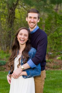 Couple laughing and embracing on a green lawn, couple portrait session at a client's home in Northborough, MA
