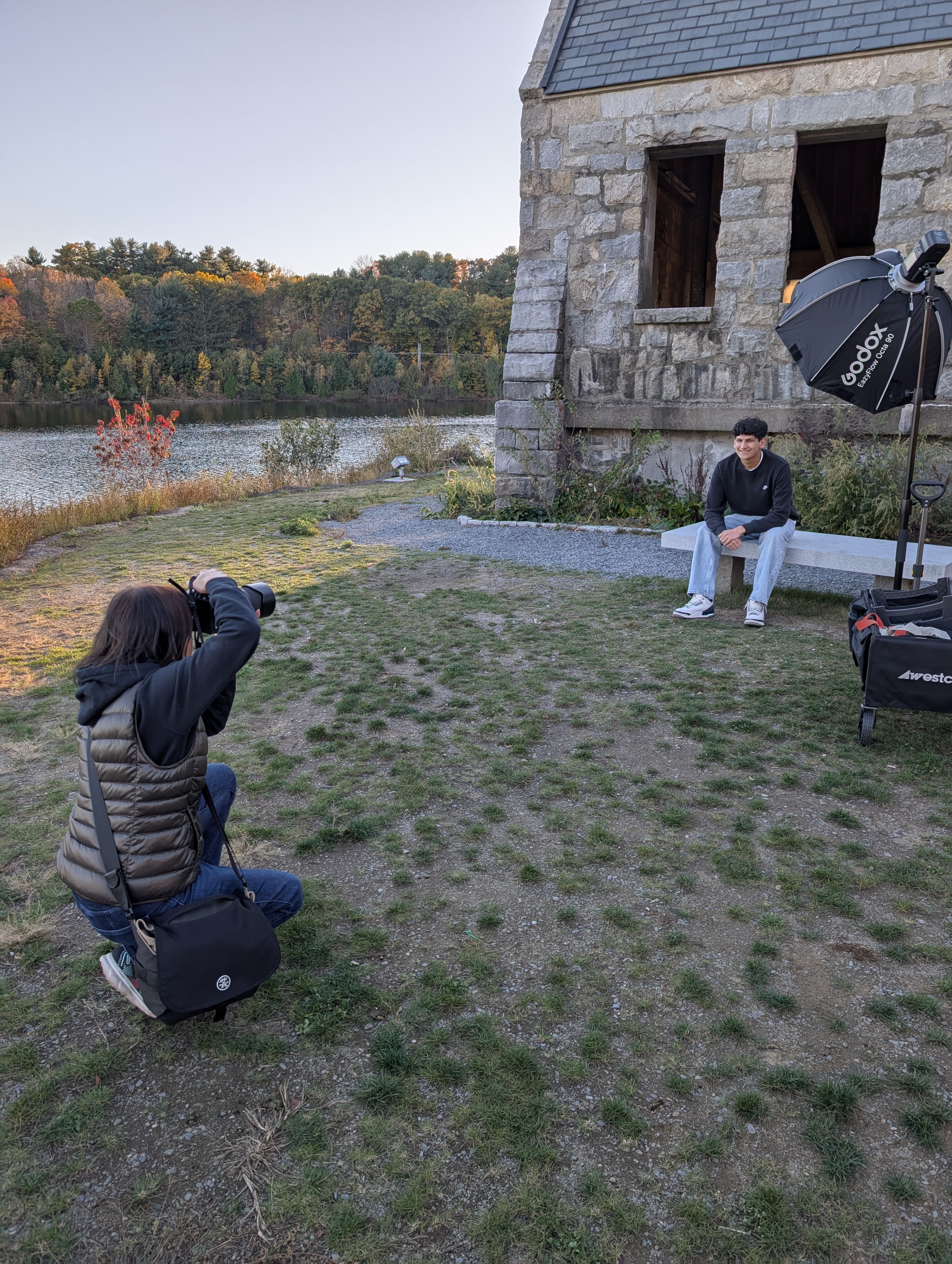Behind the scenes photo of me photographing a senior guy using studio lighting to light him